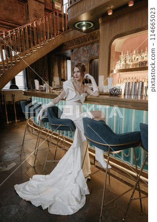 A young couple in wedding looks posing in a stylish loft bar. 114665023