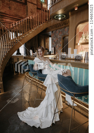 A young couple in wedding looks posing in a stylish loft bar. 114665025