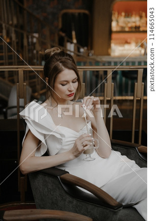 A young couple in wedding looks posing in a stylish loft bar. 114665043