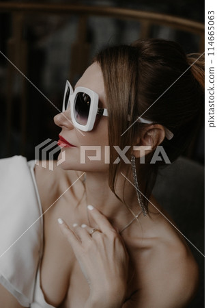 A young couple in wedding looks posing in a stylish loft bar. 114665063