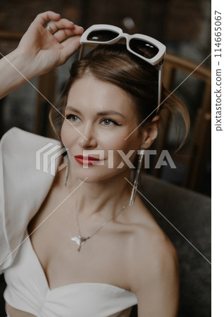 A young couple in wedding looks posing in a stylish loft bar. A young couple in wedding looks posing in a stylish loft bar. 114665067