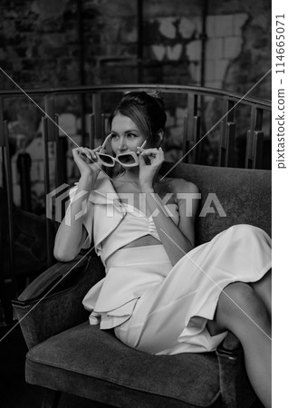 A young couple in wedding looks posing in a stylish loft bar. A young couple in wedding looks posing in a stylish loft bar. 114665071