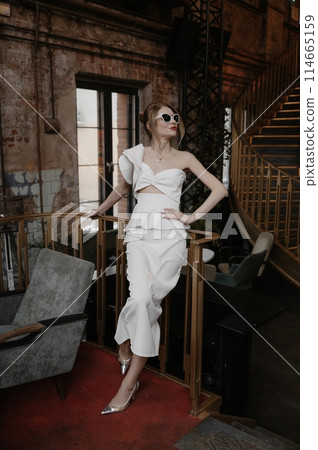 A young couple in wedding looks posing in a stylish loft bar. 114665159