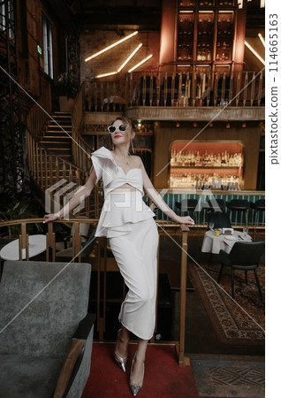 A young couple in wedding looks posing in a stylish loft bar. 114665163