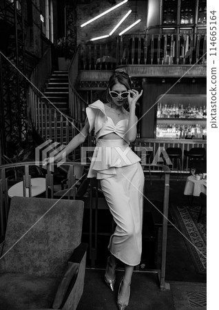 A young couple in wedding looks posing in a stylish loft bar. 114665164