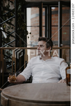 A young couple in wedding looks posing in a stylish loft bar. 114665197
