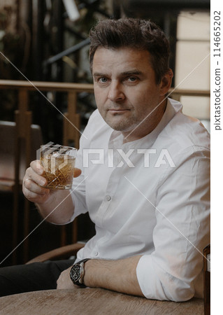 A young couple in wedding looks posing in a stylish loft bar. 114665202