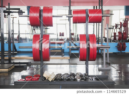 Plates to the barbell in the gym Plates to the barbell in the gym 114665529
