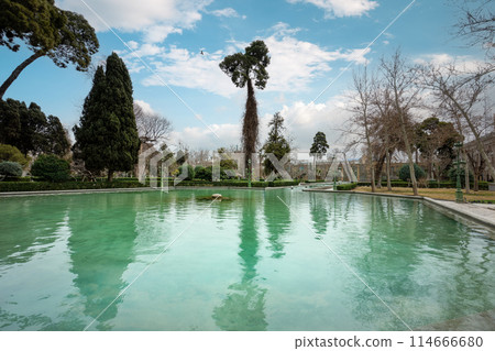 The serene reflecting pool of Golestan Palace in Tehran. 114666680