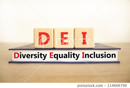 DEI diversity equality inclusion symbol. Concept words DEI diversity equality inclusion on blocks and book. Beautiful white background. Business DEI diversity equality inclusion concept. Copy space. DEI diversity equality inclusion symbol. Concept words DEI diversity equality inclusion on blocks and book. Beautiful white background. Business DEI diversity equality inclusion concept. Copy space. 114666790
