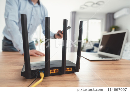Modern wi-fi router on light table in room 114667097