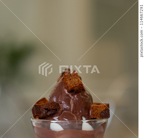 Close up of Ice Cream with chocolate syrup and brownie in a plastic cup 114667291