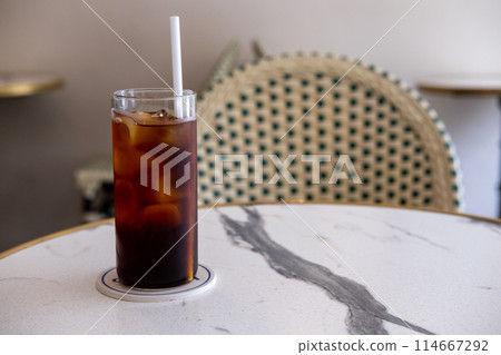 A glass of iced americano on the table 114667292