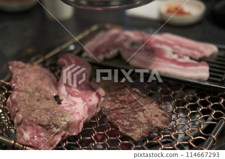 Korean Style Barbecue on stainless grill. BBQ rare meat with soft focus 114667293