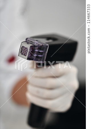 A woman receives Rf-lifting in a beauty salon. A woman receives Rf-lifting in a beauty salon. 114667333