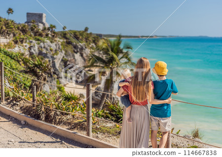 Mother and two sons tourists enjoying the view Pre-Columbian Mayan walled city of Tulum, Quintana Roo, Mexico, North America, Tulum, Mexico. El Castillo - castle the Mayan city of Tulum main temple Mother and two sons tourists enjoying the view Pre-Columbian Mayan walled city of Tulum, Quintana Roo, Mexico, North America, Tulum, Mexico. El Castillo - castle the Mayan city of Tulum main temple 114667838