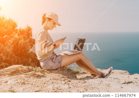 Woman sea laptop. Business woman, freelancer with laptop working over blue sea beach. Happy smiling girl relieves stress from work. Freelance, remote work on vacation, digital nomad, travel concept Woman sea laptop. Business woman, freelancer with laptop working over blue sea beach. Happy smiling girl relieves stress from work. Freelance, remote work on vacation, digital nomad, travel concept 114667974