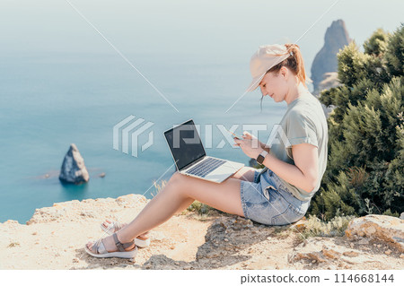 Woman sea laptop. Business woman, freelancer with laptop working over blue sea beach. Happy smiling girl relieves stress from work. Freelance, remote work on vacation, digital nomad, travel concept Woman sea laptop. Business woman, freelancer with laptop working over blue sea beach. Happy smiling girl relieves stress from work. Freelance, remote work on vacation, digital nomad, travel concept 114668144