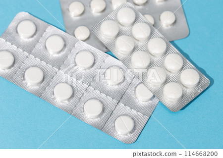 Blister pills on blue background 114668200