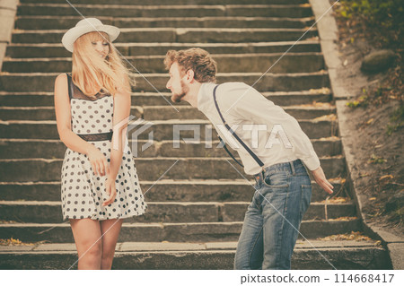 Loving couple retro style flirting on stairs Loving couple retro style flirting on stairs 114668417