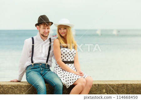 Loving couple retro style dating on sea coast Loving couple retro style dating on sea coast 114668450