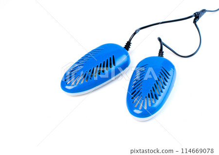 blue electric shoe dryer isolated on a white background. shoe protection and hygiene in the autumn-winter period. blue electric shoe dryer isolated on a white background. shoe protection and hygiene in the autumn-winter period. 114669078