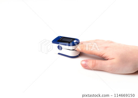 Close up of Finger and hand in an Oximeter Device. Pulse oximeter on white background. Close up of Finger and hand in an Oximeter Device. Pulse oximeter on white background. 114669150