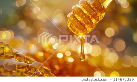 Honey dripping from the wooden honey dropper over thick golden honeycomb on a blurred background. A close up view of the natural organic sweet product. Honey dripping from the wooden honey dropper over thick golden honeycomb on a blurred background. A close up view of the natural organic sweet product. 114673389