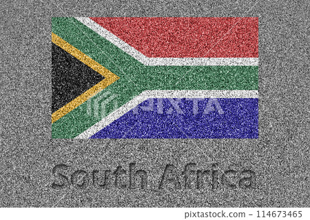 The South African flag painted on a stone slab with the word "South Africa" carved into it 114673465