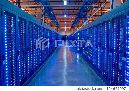 Rows of servers fill a long building hallway in a data center Rows of servers fill a long building hallway in a data center 114674097