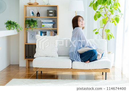 A woman relaxing in the room A woman relaxing in the room 114674400