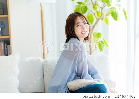 A woman relaxing in the room 114674402