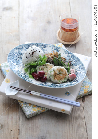 Lotus root burger and rice balls on a plate Lotus root burger and rice balls on a plate 114674603