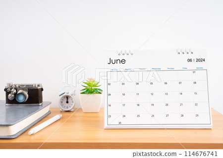 Desktop Calendar for June 2024 year and vintage camera with diary for Planner to plan 114676741