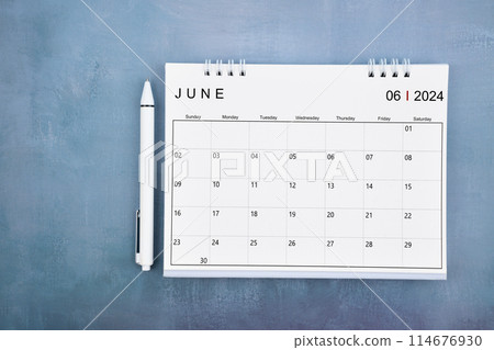 Directly above view of June 2024 desk calendar and pen on wooden background. 114676930