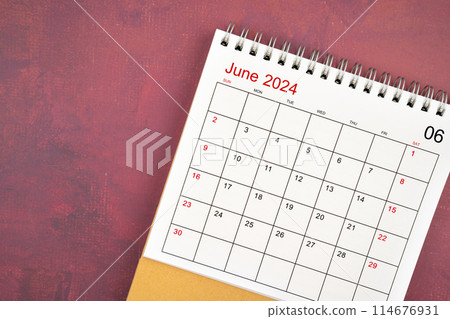June 2024 desk calendar on red background. 114676931