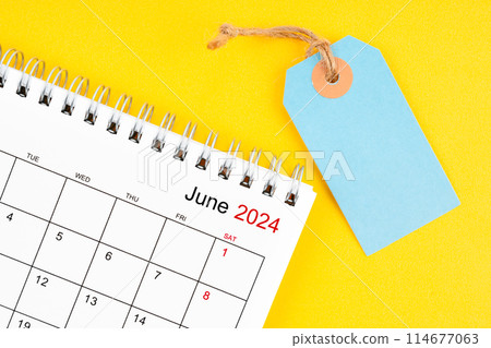June 2024 desk calendar with blank price tag on yellow. 114677063