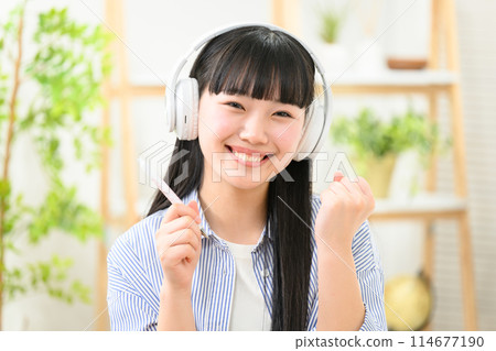 High school student girl headphones fist pump High school student girl headphones fist pump 114677190