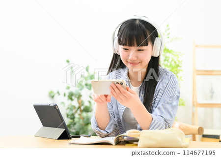 High school girl headphones smartphone 114677195