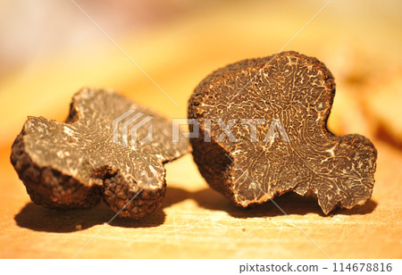 black truffles on a chopping board 114678816