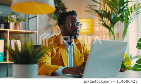 A professional working in a modern office environment, surrounded by plants and vibrant decor, highlighting a balanced and aesthetically pleasing workspace. 114680428