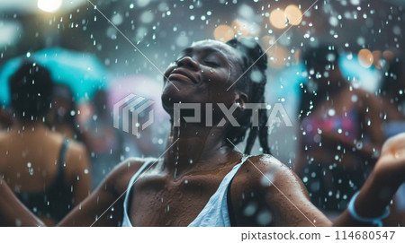 summer music festival-goer dancing in the rain at a summer music festival 114680547