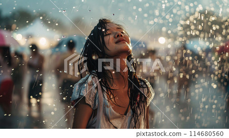 summer music festival-goer dancing in the rain at a summer music festival 114680560