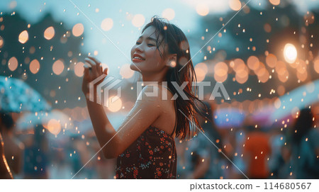 summer music festival-goer dancing in the rain at a summer music festival 114680567