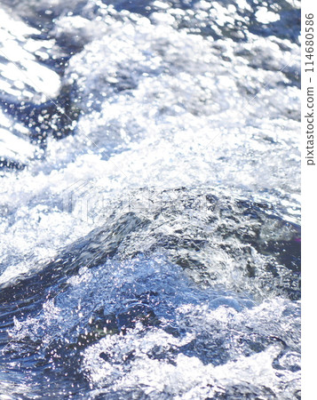 A wave crashing into the shore, with the water splashing A wave crashing into the shore, with the water splashing 114680586