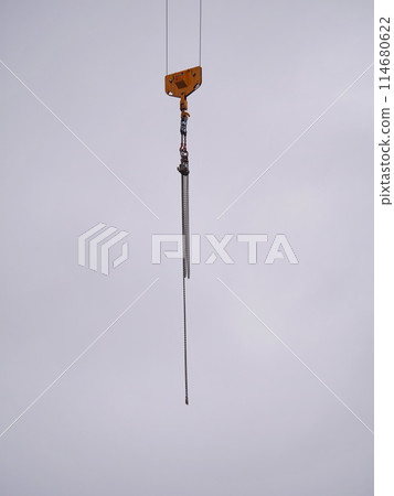 A chain hangs from a crane 114680622