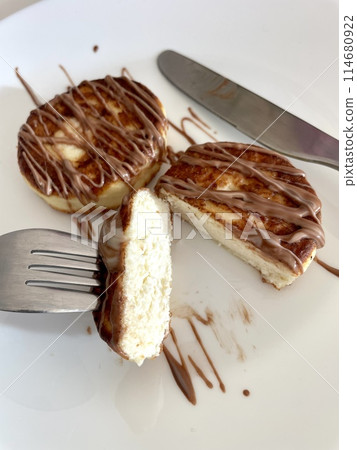 Two cheesecakes for breakfast on a white plate Two cheesecakes for breakfast on a white plate 114680922