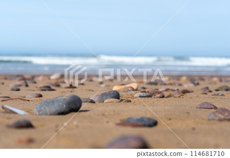 Colored Pebble Beach Texture Background, Sand and Rocky Shore Pattern, Red Morocco Beach, Africa 114681710