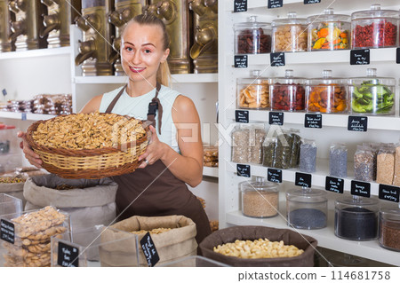 Girl seller is demonstraiting walnut in bag Girl seller is demonstraiting walnut in bag 114681758