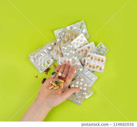 Hand with Color Pill Capsules on Green Background, Overdose Concept, Opioid Problem, Poison, Analgesic Hand with Color Pill Capsules on Green Background, Overdose Concept, Opioid Problem, Poison, Analgesic 114682038